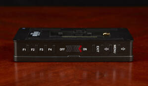 The top has four custom function buttons, the power switch, and menu navigation buttons.