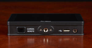 The bottom has the 1/4" 20 mounting hole, the Camera Remote port, and the USB jack for firmware updates.