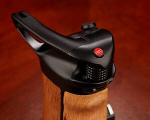 The record start/stop button is on top and the knurled motor control wheel is just below it.